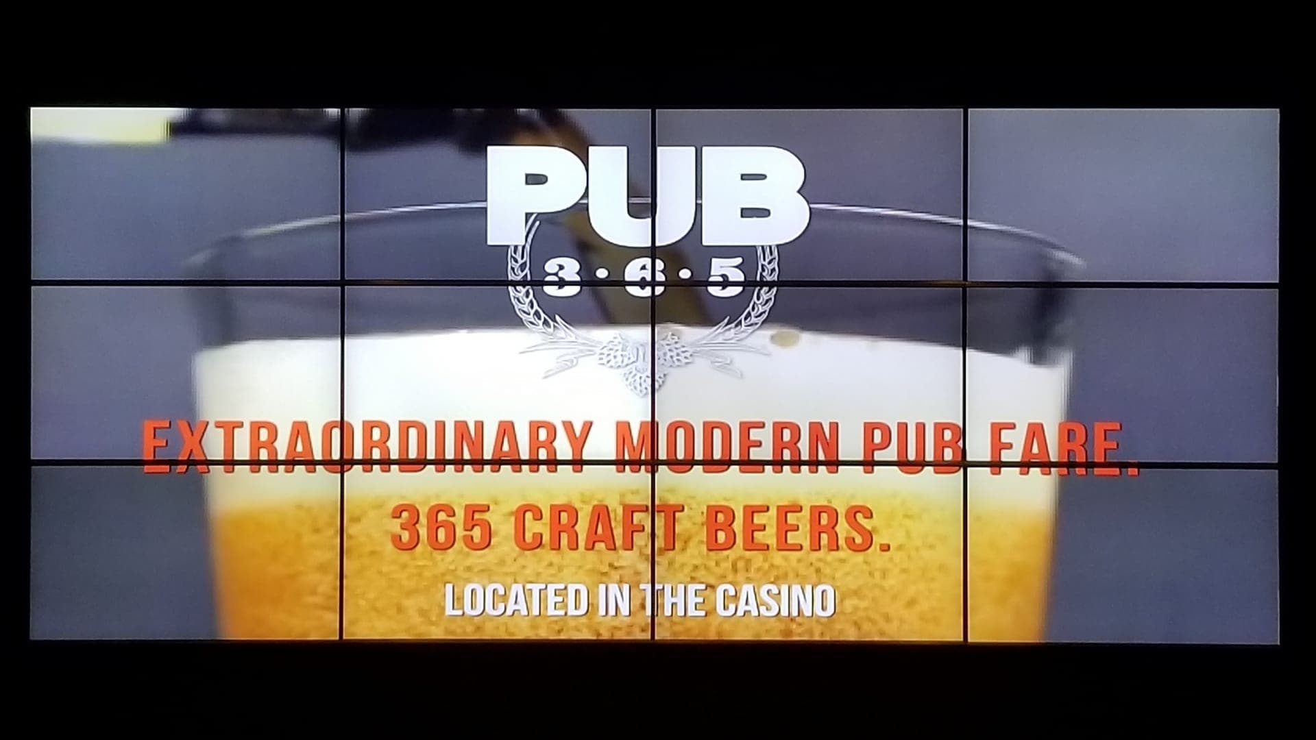 Video wall showing Pub 365 branding and drink specials